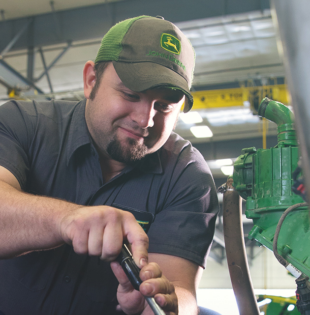 John Deere mechanic performing repairs