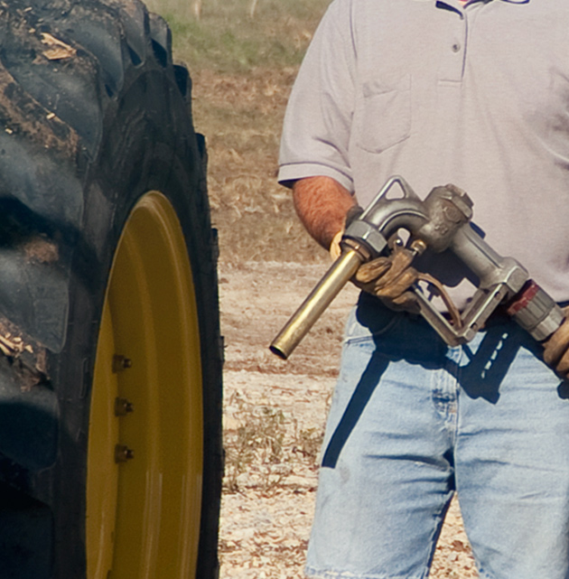 Farmer preparing to fuel tractor